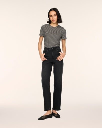 Woman wearing SPANXshape Authentic 360 90s Straight Leg Jeans in Deep Space washed black denim, high rise with a straight ankle-length leg, styled with a striped tee and black woven flats