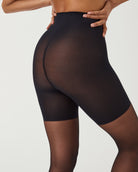 SPANXshape Original Footless Sheers in Black, back view showing smoothing through the seat and thighs