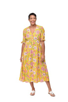 Woman wearing a yellow floral dress on a white background