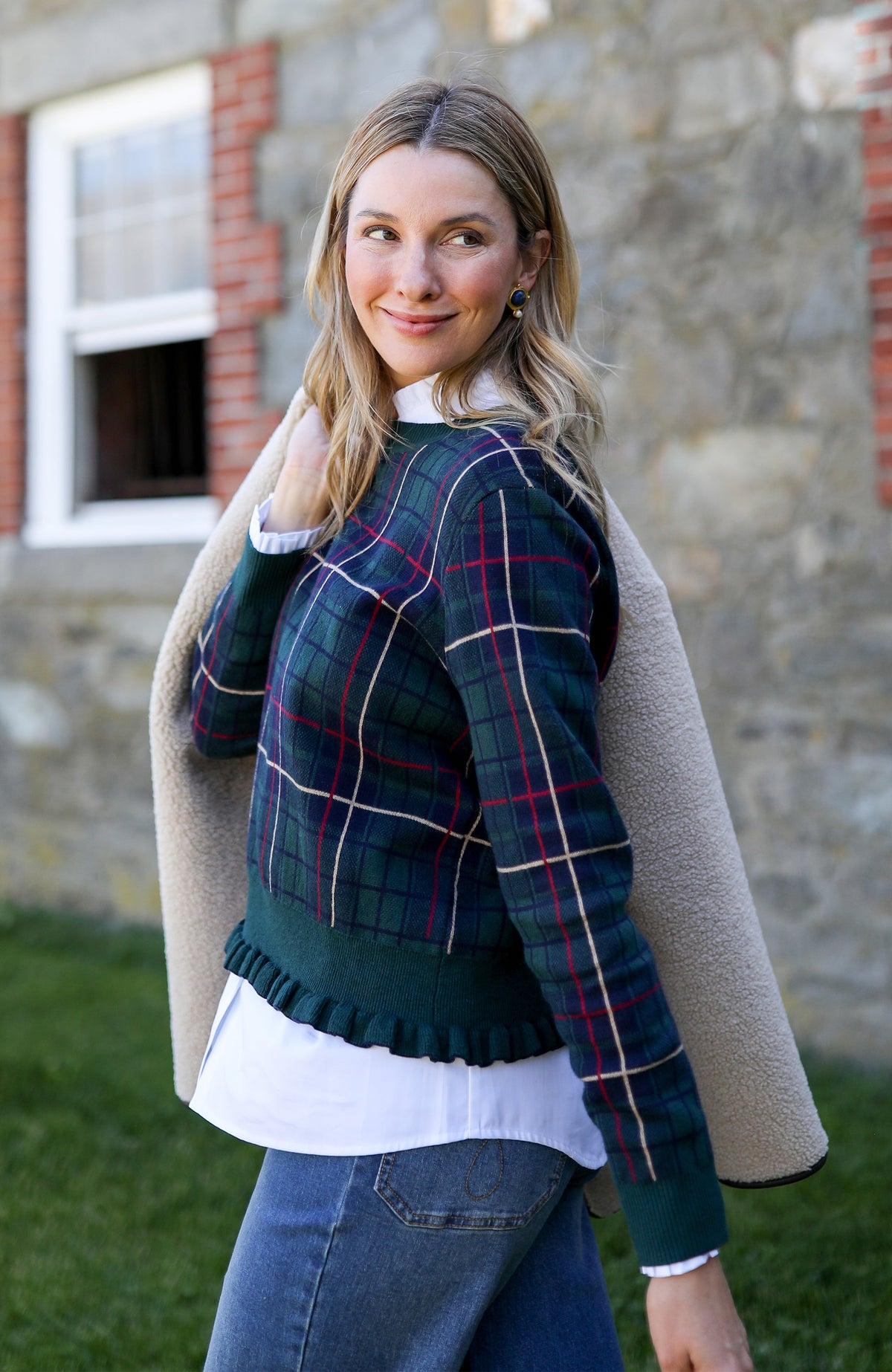 Tyler Böe Hailey Novelty Ruffle Sweater in Ponderosa Pine plaid styled with a camel coat outdoors