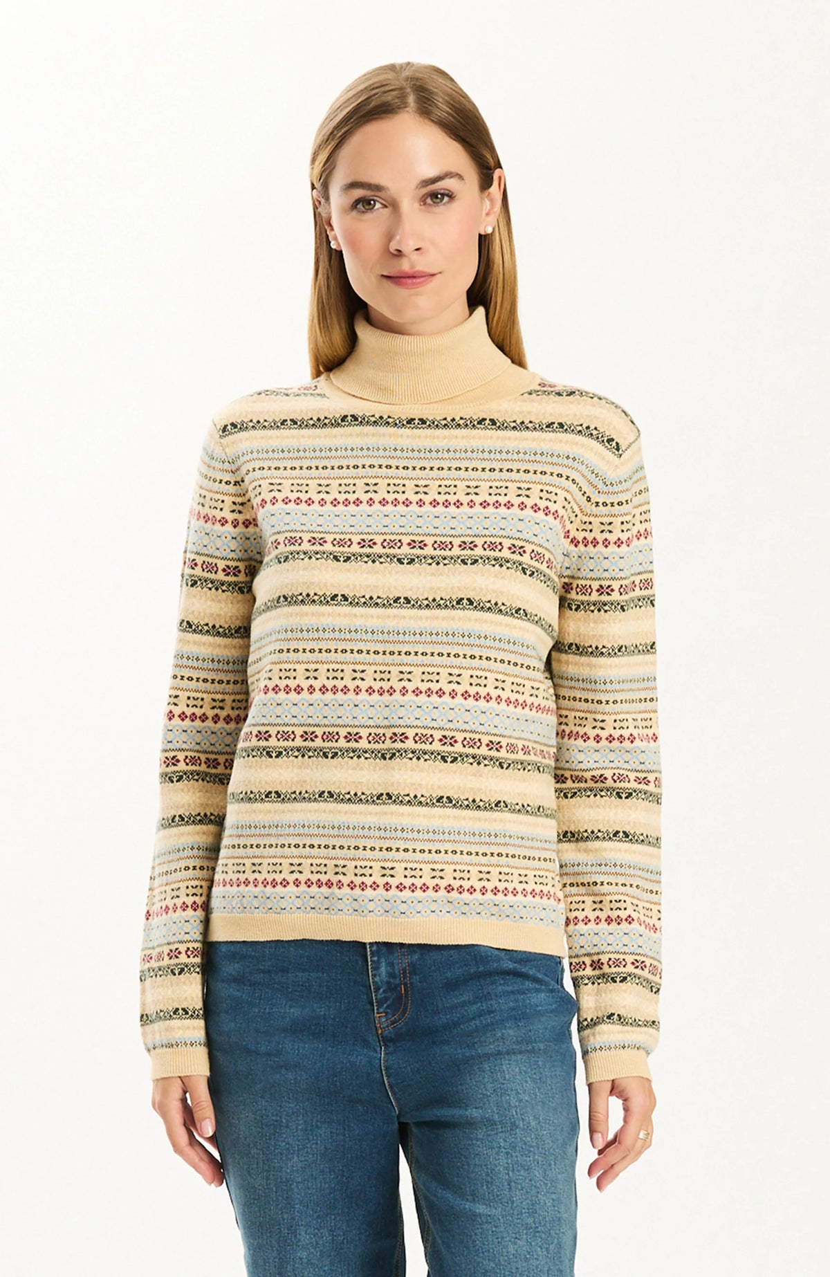 Woman wearing the Tyler Boe Jen Fair Isle Turtleneck Sweater in a cream multicolor Fair Isle pattern with blue jeans