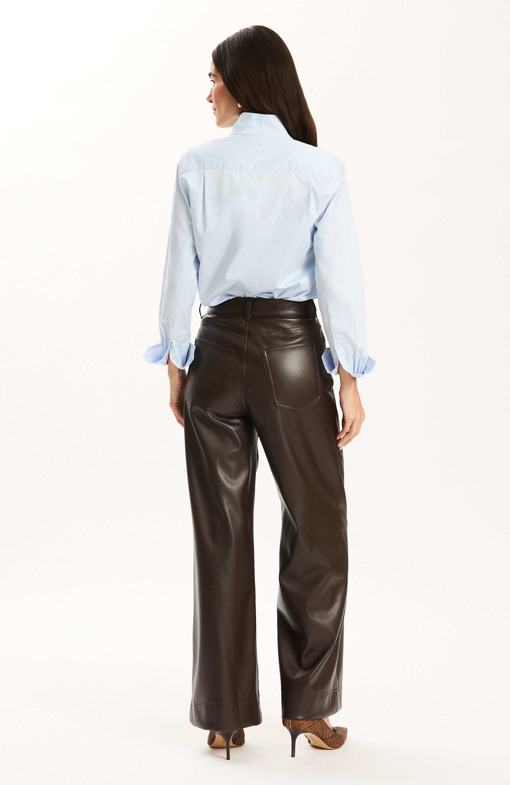 Back view of the Tyler Böe Natalie Sateen Shirt in Blue tucked into leather pants
