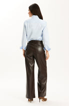 Tyler Böe Natalie Sateen Shirt in blue, back view, tucked into leather pants