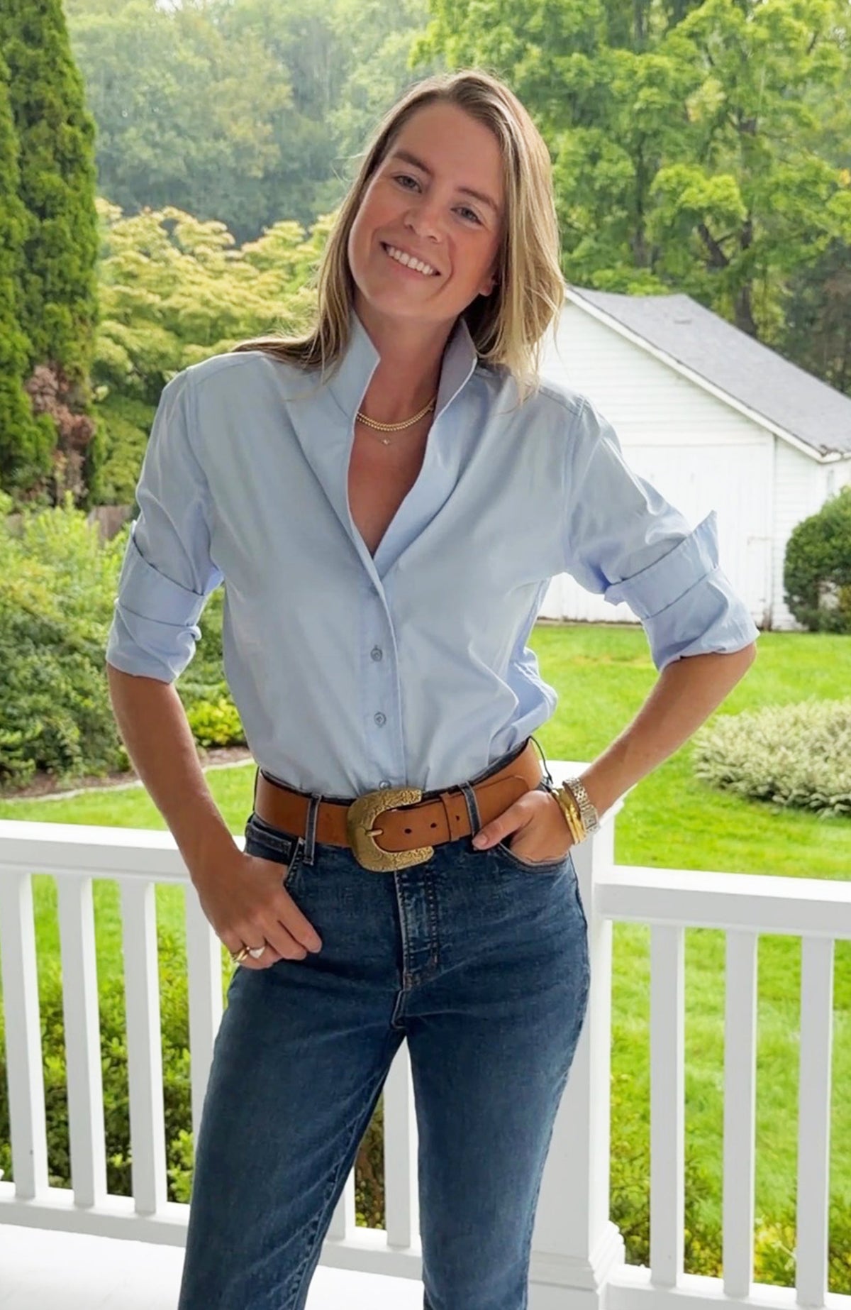 Tyler Böe Natalie Sateen Shirt in blue, styled outdoors with jeans and a belt