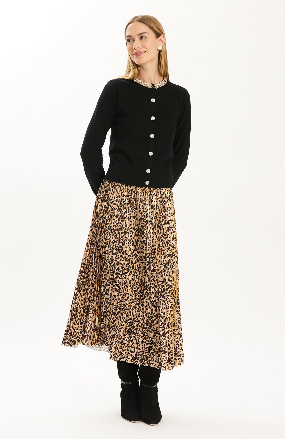 Tyler Böe Pleated Animal Print Midi Skirt styled with a black cardigan and boots