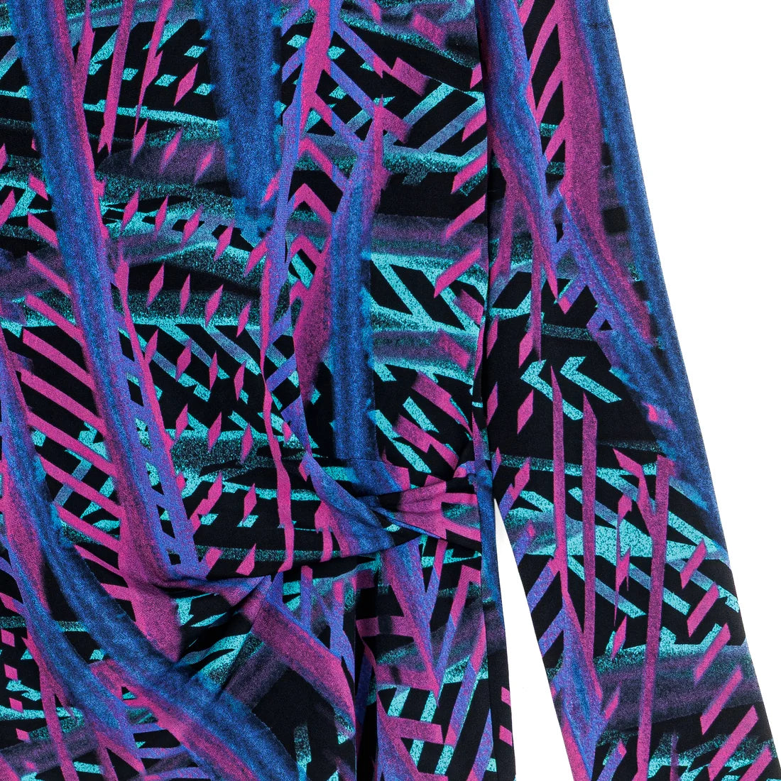 Close-up of top with a vibrant, multicolored pattern on a white background