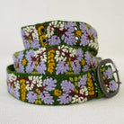 Floral patterned belt with a metal buckle on a white background