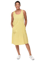 Woman wearing a yellow checkered dress on a white background