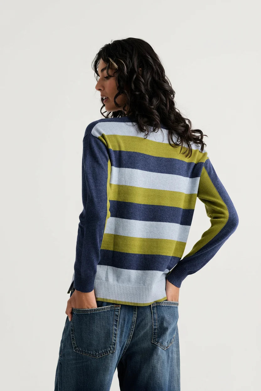 Back view of the Zaket & Plover Color Theory V sweater showing navy, soft blue and olive green stripes, styled with blue jeans